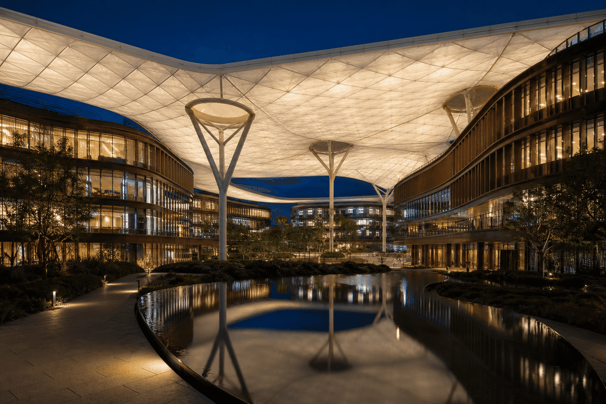 Night view of commercial building softly glowing through ETFE
