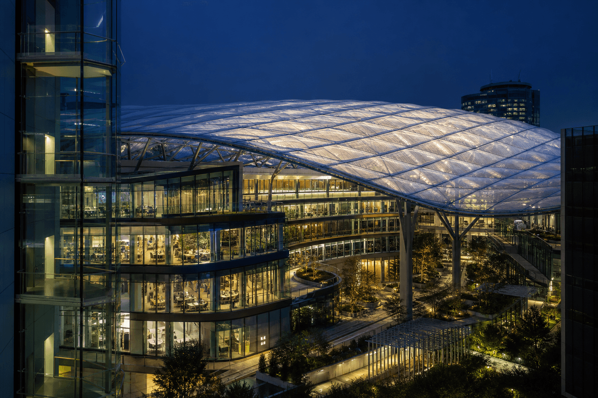 Night view of corporate campus softly glowing through ETFE