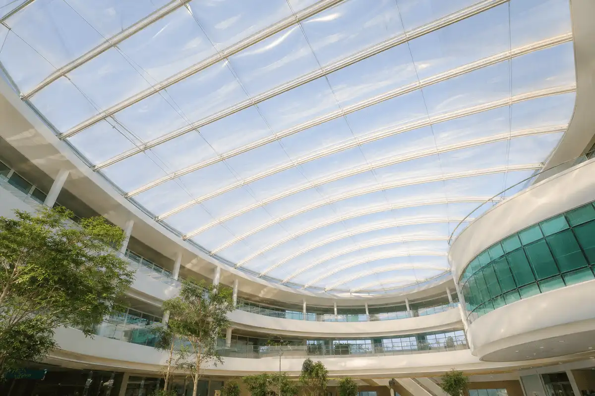 Interior looking up at a daylit ETFE cushion roof in a modern healthcare facility with ETFE roof