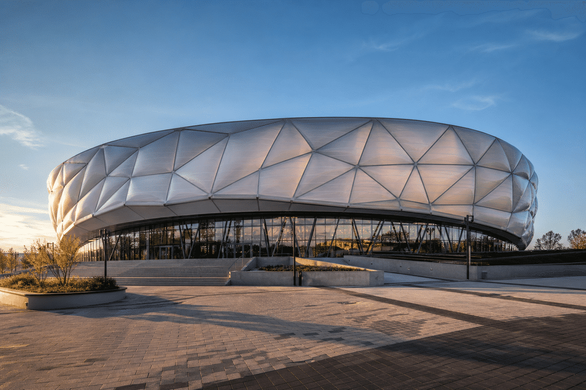 Exterior of a modern indoor sports arena with ETFE roof