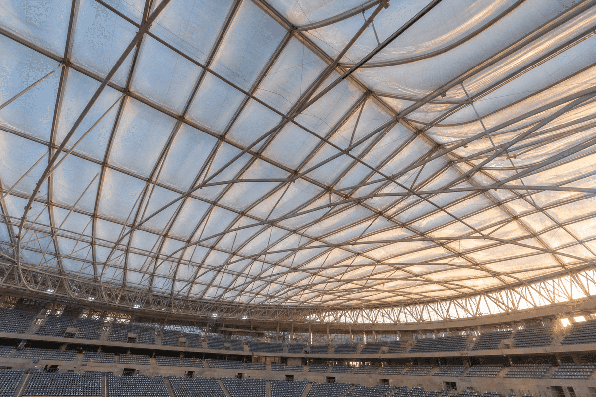 Interior looking up at a daylit ETFE cushion roof in a modern indoor sports arena with ETFE roof
