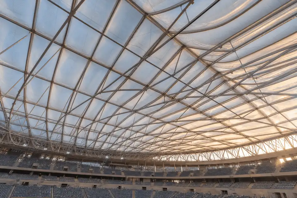 Interior looking up at a daylit ETFE cushion roof in a modern indoor sports arena with ETFE roof