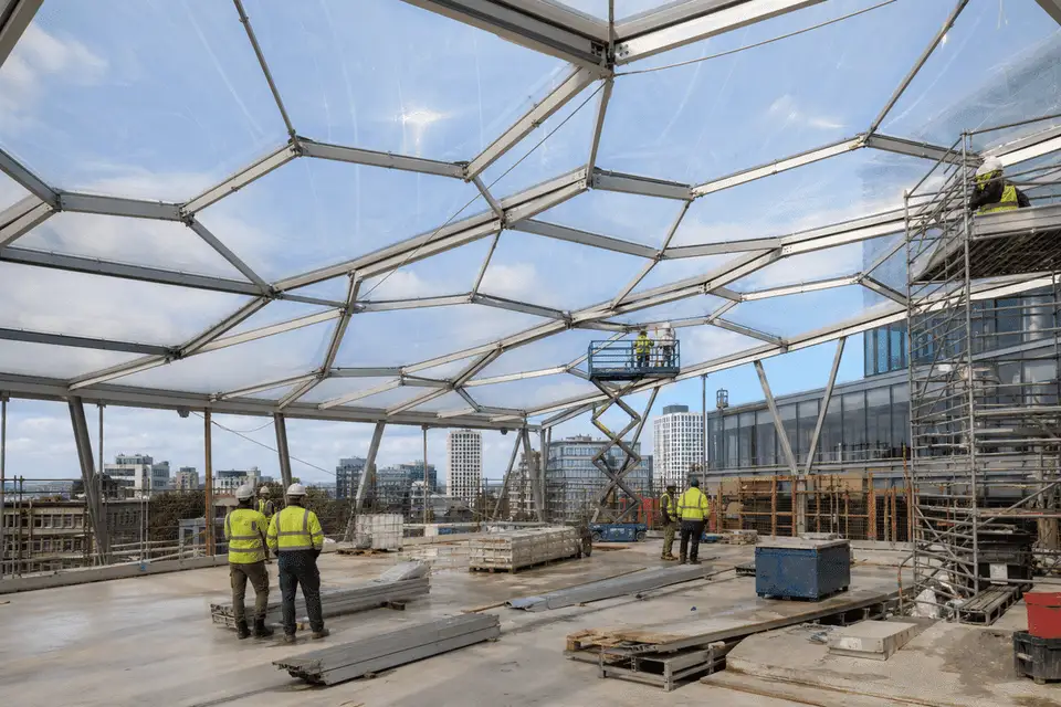 Construction stage installing ETFE modules on office steel grid — Office Building ETFE Roofing systems