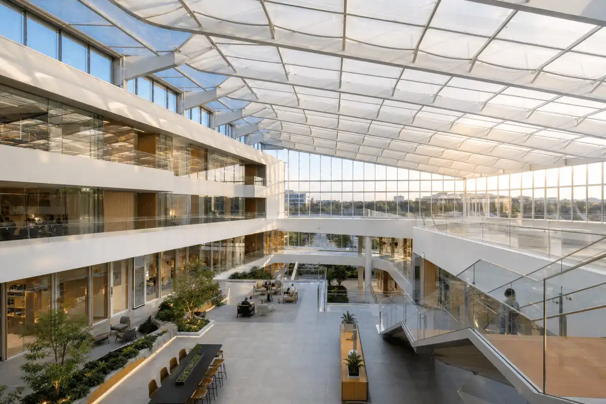 Daylit office workplace atrium under a translucent ETFE roof — Office Building ETFE Roofing systems