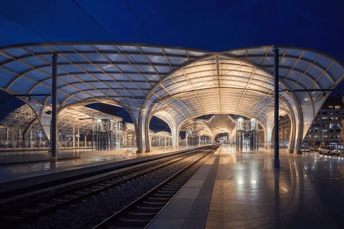 Night view of railway station softly glowing through ETFE roof — Railway Station ETFE Roofing systems