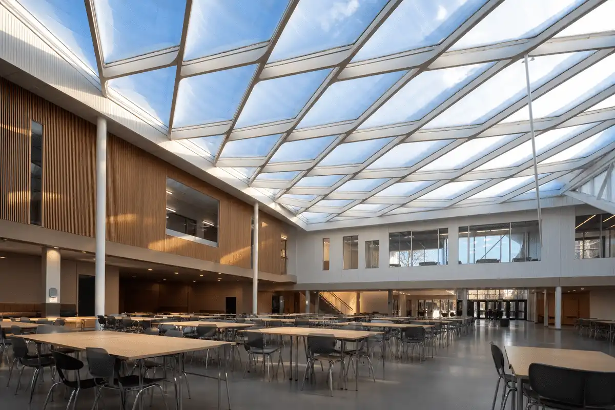 Natural daylight washing a school assembly hall through an ETFE roof — School ETFE Roofing systems