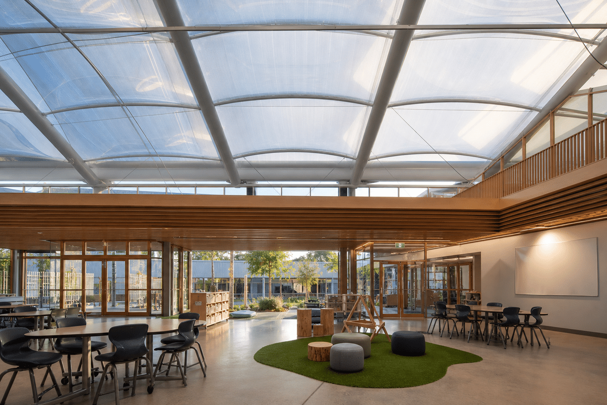 Interior looking up at a daylit ETFE cushion roof in a modern school with ETFE roof