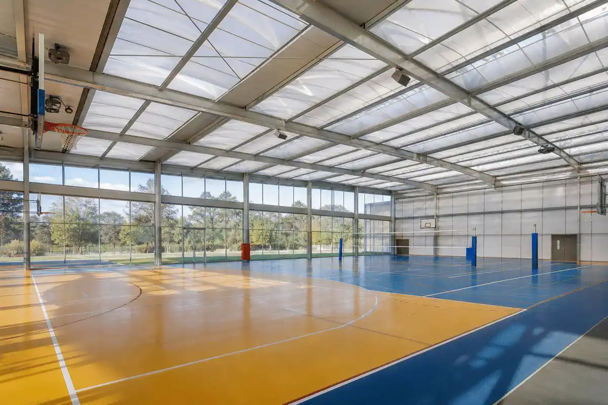 Natural daylight washing a sports complex hall through an ETFE roof — Sports Complex ETFE Roofing systems