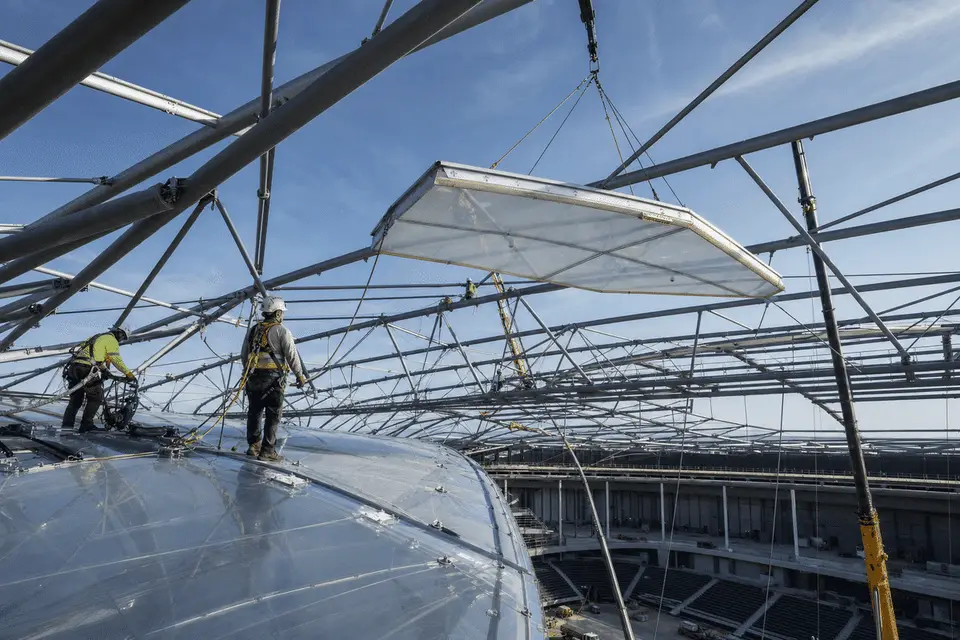 Construction crew installing ETFE modules on roof grid — Sports Complex ETFE Roofing