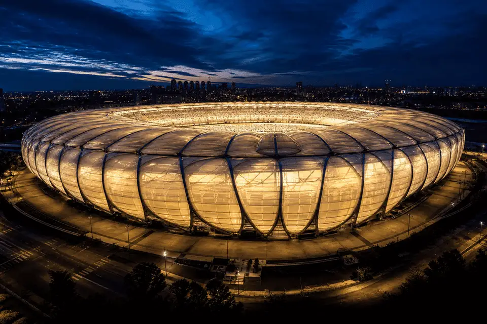 Night view of stadium softly glowing through ETFE roof — Stadium ETFE Roofing