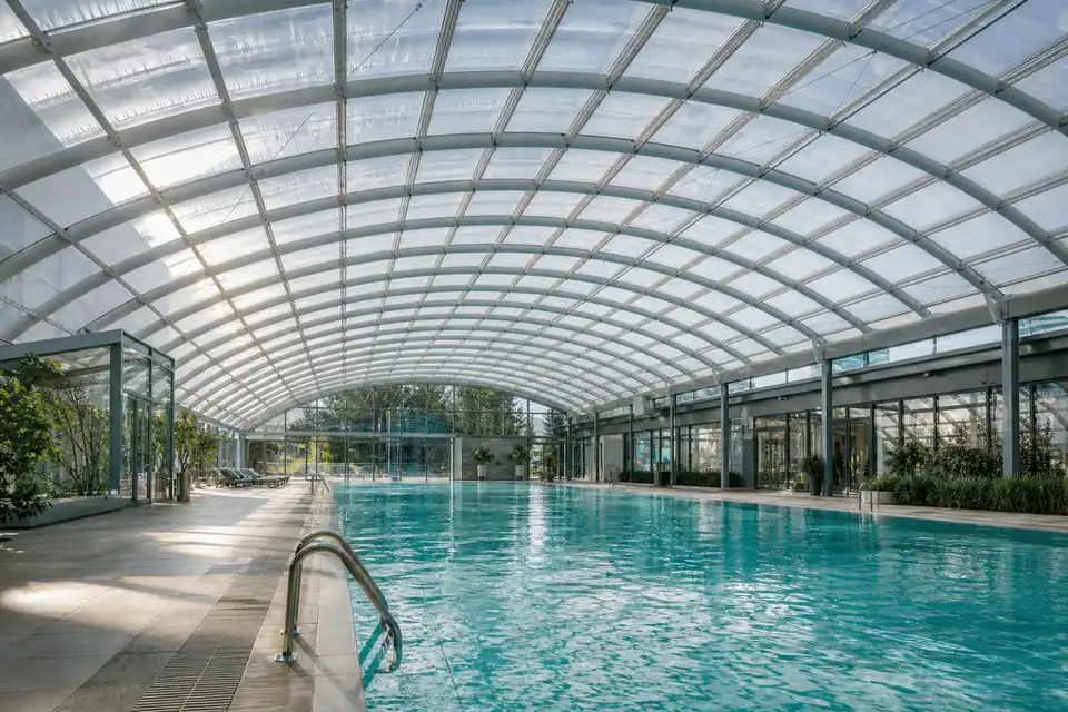 Natural daylight washing an indoor pool hall through an ETFE roof — Swimming Pool ETFE Roofing systems