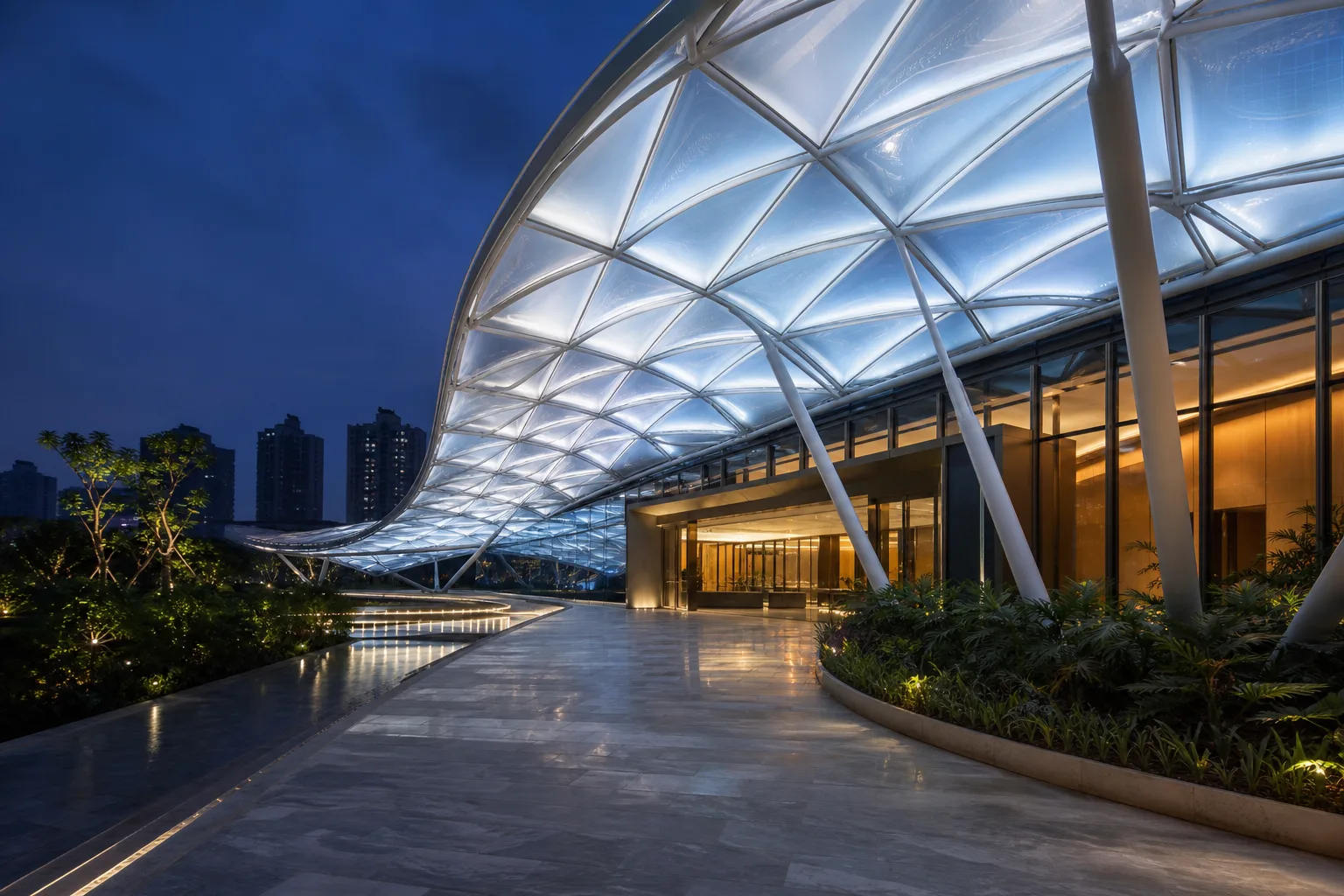 Luminous ETFE canopy plaza leading to a contemporary architecture studio at blue hour