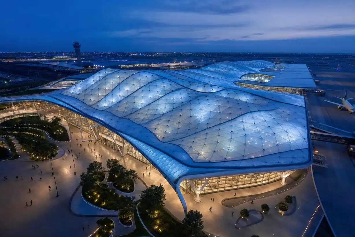 Aerial blue-hour view of an ETFE air cushion roof over an international airport terminal — ETFE film supplier India