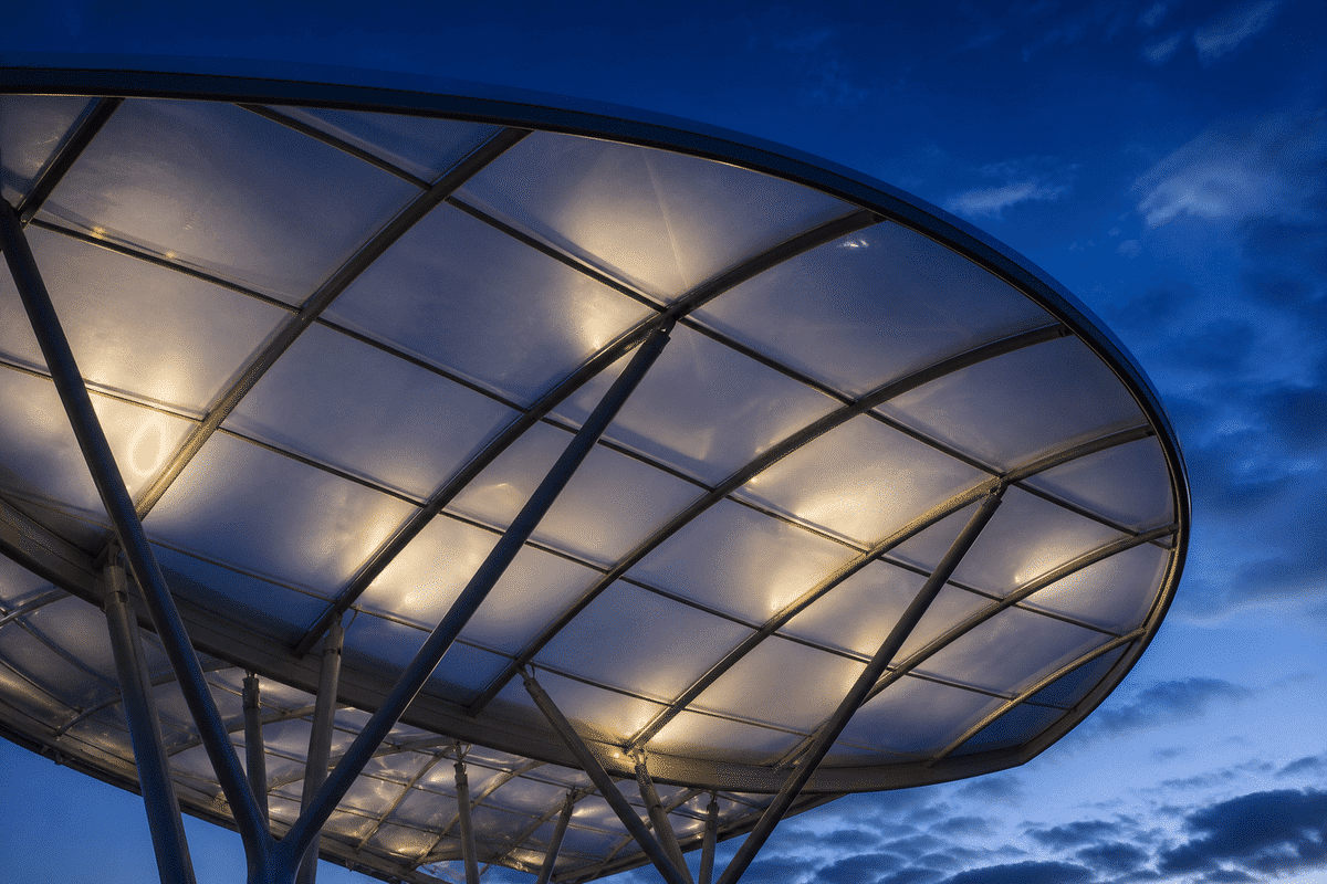 Waterfront pavilion single-layer ETFE sail at sunset