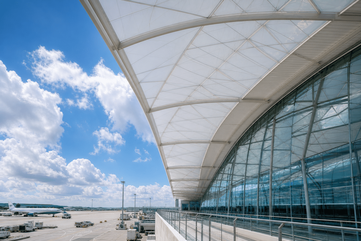 Airport terminal ETFE canopy beside glass facade section