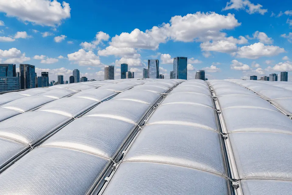 Stadium ETFE roof section adjacent to glass VIP facade — ETFE Vs Glass