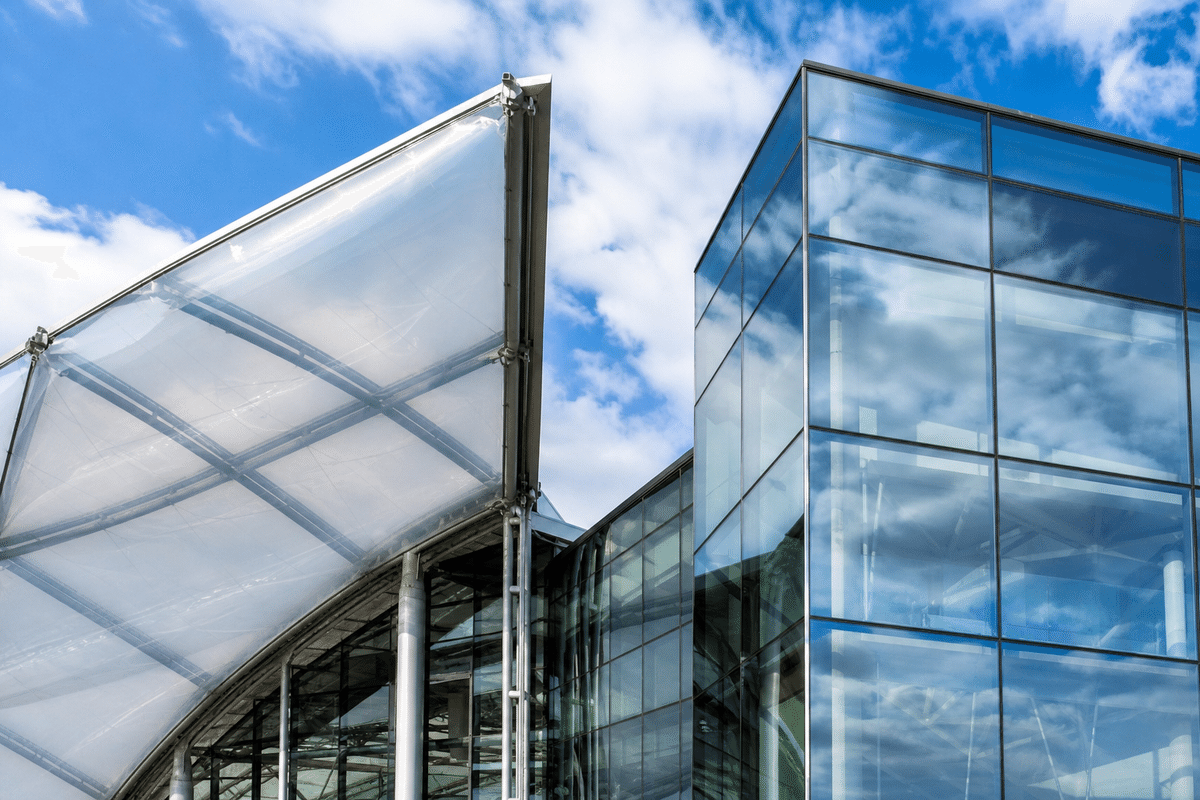 Atrium contrasting ETFE cushion roof with glass curtain wall