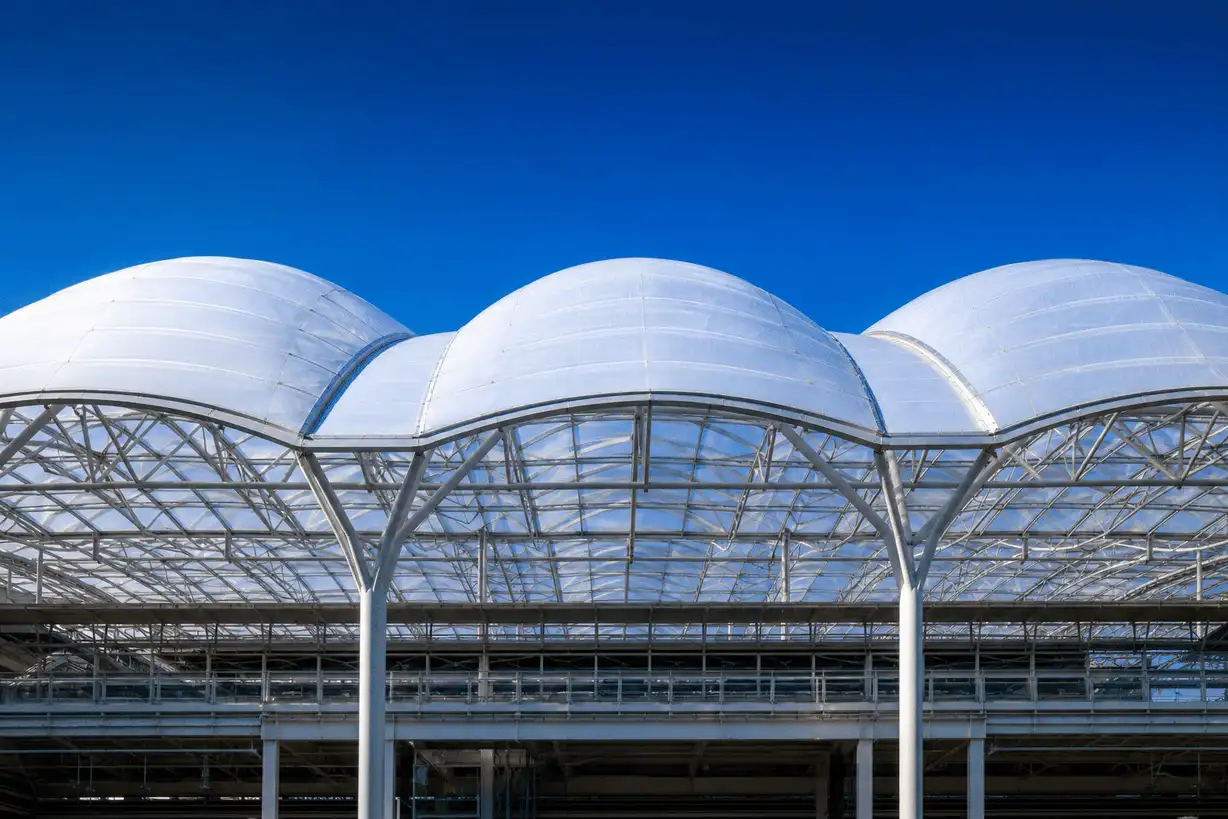 Luminous multi-bay ETFE roof under clear blue sky — Technical Library